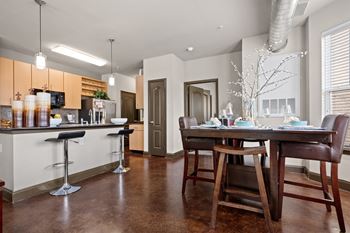 An open kitchen and dining room with a table and chairs